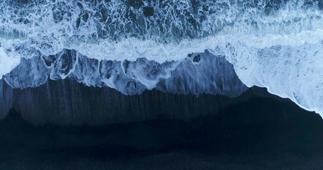 Wide birds eye view aerial of ocean crashing onto beach - Powered by Adobe