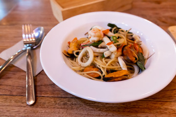 Spaghetti with Seafood isolated on wood Background

