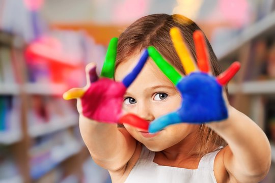 Little cute girl with hands in colored