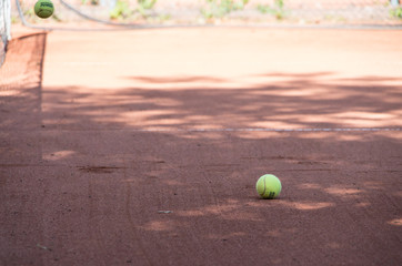 Tennis ball laying on court