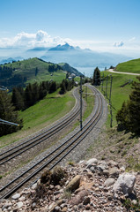 Fototapeta premium Train tracks (railway) on mount rigi to take guests from various stations to the peak of the mountain and back down.