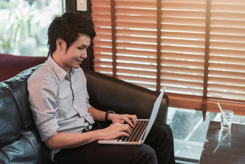Fototapeta premium man using laptop computer in cafe