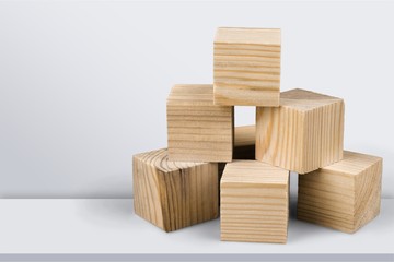 Wooden cubes on table background