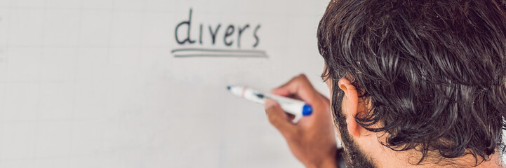 diver writes a marker on the board BANNER, long format