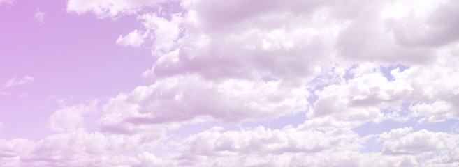A blue sky with lots of white clouds of different sizes