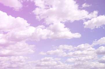 A blue sky with lots of white clouds of different sizes