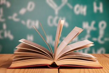 Open book on old wooden table