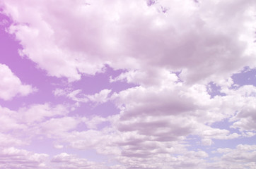 A blue sky with lots of white clouds of different sizes