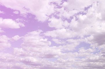A blue sky with lots of white clouds of different sizes