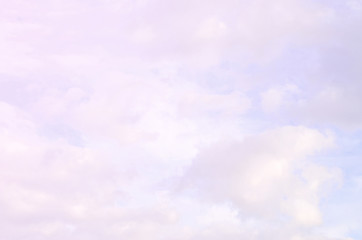 Obraz na płótnie Canvas A blue cloudy sky with many small clouds blocking the sun