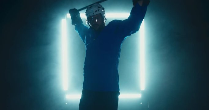 FIXED Portrait of Caucasian male ice hockey player in uniform, looking into the camera, dramatic lighting. 4K UHD 60 FPS SLOW MOTION