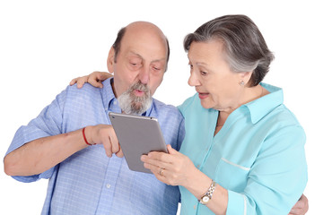 Shocked senior couple with tablet pc