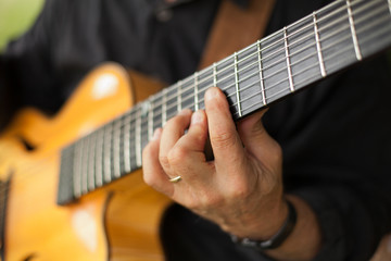 Fototapeta na wymiar Detail of guitarist playing seven string guitar