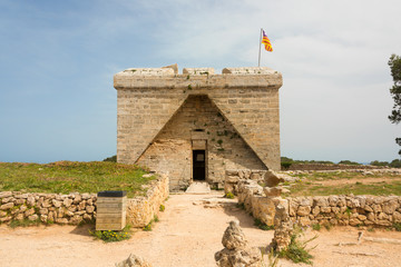 The old defence tower of Punta de N'Amer from the time of the Spanish civil war built of rocks from the east coast of the Spanish Mediterranean island Mallorca