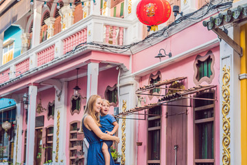 Mom and son are tourists on the Street in the Portugese style Romani in Phuket Town. Also called Chinatown or the old town