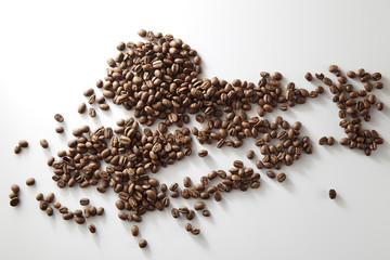 roasted coffee beans poured from clear glass