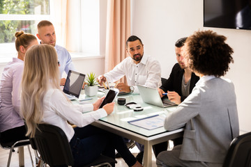 Group Of Businesspeople Sitting In Office