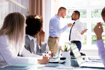 Two Male Colleagues Fighting In Office