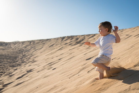 Boy Running Down Sand Dune