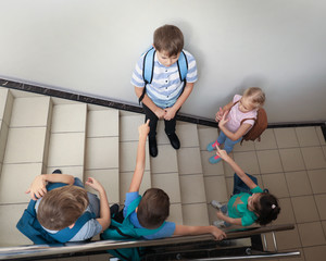 Little children bullying their classmate indoors