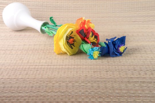 Origami flowers / paper flowers in a fallen white ceramic vase