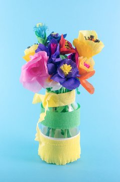 Colorful origami flowers / paper flowers / bunch of flowers on a blue background