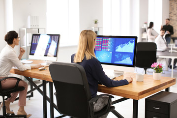 Woman working with stock data in office. Finance trading