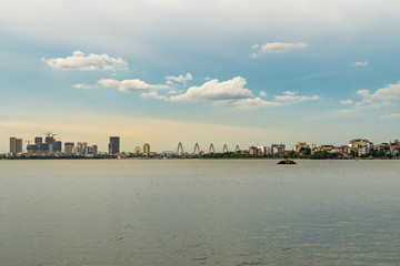Fototapeta premium West Lake in Hanoi, Vietnam, with buildings on horizon