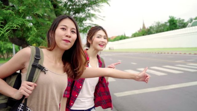 Slow motion - Traveler backpacker Asian women lesbian lgbt couple travel in Bangkok, Thailand. Happy young female spending holiday trip at amazing landmark and enjoy her journey in traditional city.