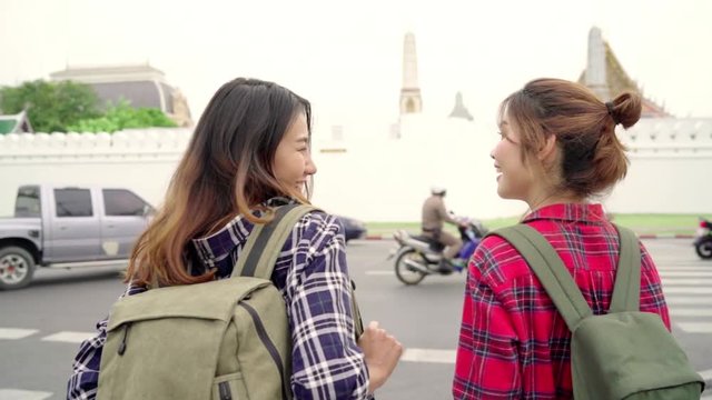 Slow motion - Traveler backpacker Asian women lesbian lgbt couple travel in Bangkok, Thailand. Happy young female spending holiday trip at amazing landmark and enjoy her journey in traditional city.