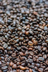 Roasted coffee beans background with depth of field.