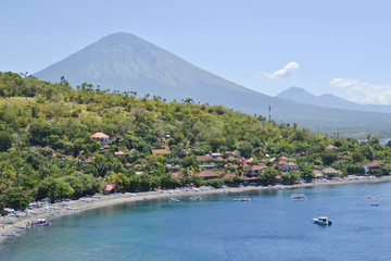 Amed beach and blue lagoon with volcano Agung on background. Amed village, East of Bali, Indonesia.