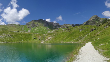 Naklejka na ściany i meble The Grunwaldsee in Obertauern near Hochalm and Seekarspitze. Austria