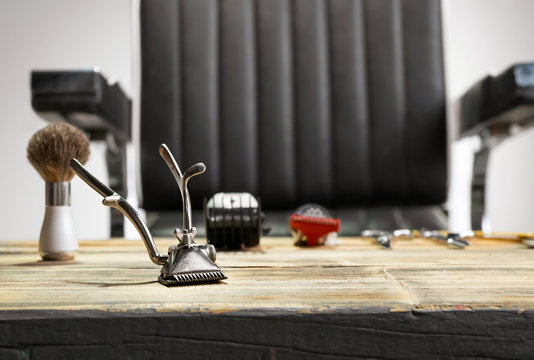 Hand-help hair clipper for barber on wooden table in barber shop