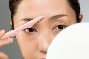 Obraz premium 眉の間を剃る女性