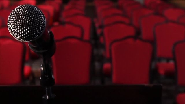 On an empty stage microphone in front of an empty hall. Scene. Microphone on stage close-up