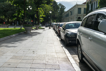 Parallel parking cars on urban street. Outdoor parking on road