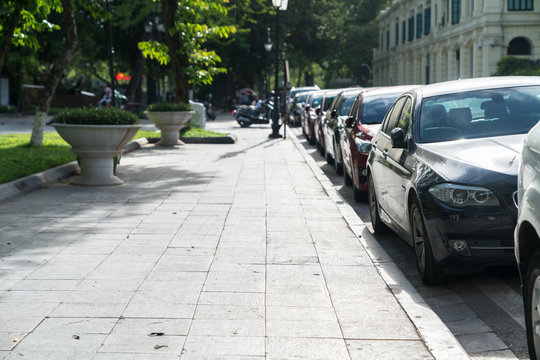 Parallel parking cars on urban street. Outdoor parking on road