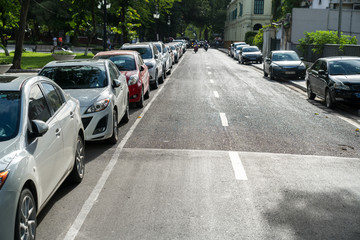 Parallel parking cars on urban street. Outdoor parking on road