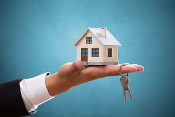 Businessperson with house and key