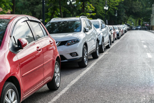 Parallel parking cars on urban street. Outdoor parking on road