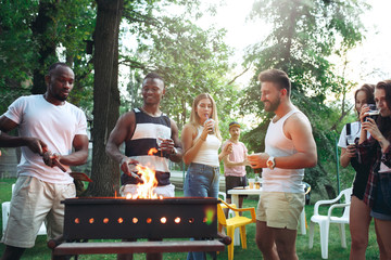 Group of friends making barbecue in the backyard. concept about good and positive mood with friends