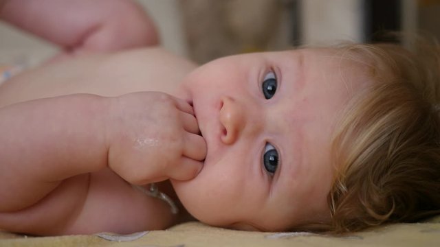 Suckling baby teething - he puts his fingers in his mouth and scratching the gums