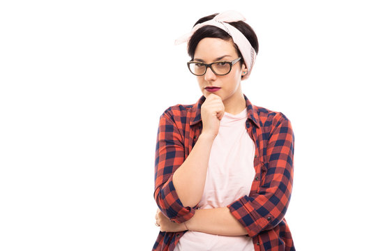 Young pretty pin-up girl wearing glasses showing reflecting gesture.