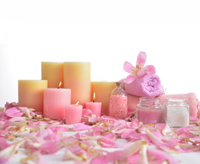 Many pink tropical petals and five candle ,and rolled towel
