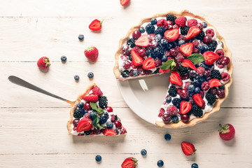 Delicious berry pie on white wooden table