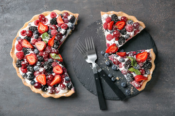 Delicious pie with ripe berries on table, top view