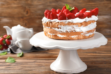 Dessert stand with delicious strawberry cake on wooden table