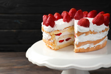 Delicious strawberry cake on dessert stand, closeup