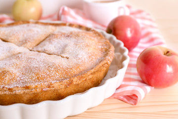 Plate with delicious apple pie on wooden table, closeup